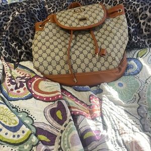 Wendy keen backpack with a zipper on back, a middle zipper down middle.